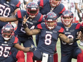 Montreal Alouettes quarterback Vernon Adams, No. 8, celebrates with teammates after scoring a touchdown against the Ottawa Redblacks in Montreal on Aug. 2, 2019.