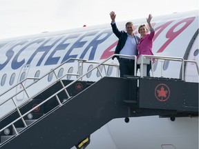 Conservative Leader Andrew Scheer and his wife Jill waves as they board the campaign plane in Ottawa earlier this month.