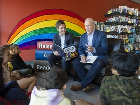 Education Minister Rob Fleming and Premier John Horgan explain the Raise-a-Reader campaign to students at Fraser River Middle School in Vancouver. Photo: Gerry Kahrmann/Postmedia
