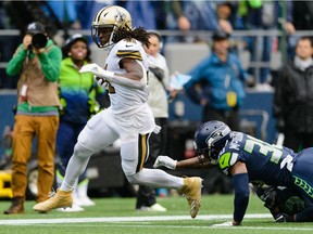 Sep 22, 2019; Seattle, WA, USA; New Orleans Saints running back Alvin Kamara (41) runs the ball in for a touchdown against the Seattle Seahawks during the first half at CenturyLink Field. Mandatory Credit: Steven Bisig-USA TODAY Sports