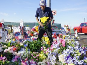 Antonio Basco, who's wife Margie Reckard was one of 22 persons killed by a gunman at a local Walmart, lays flowers in her honor at a makeshift memorial near the scene on August 16, 2019 in El Paso, Texas.