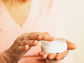 An elderly woman applies anti-wrinkle cream. A 47-year-old woman went to the emergency room whether doctors found she had been applying mercury-tainted cream on her body.