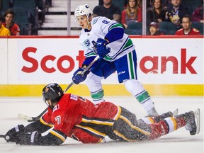 Sep 16, 2019; Calgary, Alberta, CAN; Vancouver Canucks right wing Jake Virtanen (18) controls the puck against the Calgary Flames during the overtime period at Scotiabank Saddledome. Mandatory Credit: Sergei Belski-USA TODAY Sports