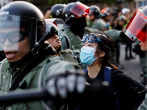 Police officers detain an anti-government protester in Sha Tin, Hong Kong, China Sept. 22, 2019.