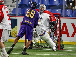 Wake:Riat Bowhunter of the Iroquois Nationals gets a shot off on England's Frankie Scigliano during the world indoor lacrosse championships at the Langley Events Centre on Sunday night. The Iroquois Nationals meet Canada tonight at 7:30 p.m. with top spot in their pool on the line.