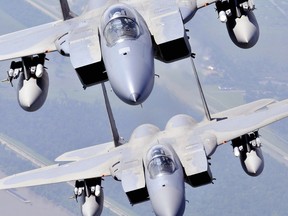 In this July 11, 2009, image, two F-15 Strike Eagles assigned to the Louisiana Air National Guard 159th Fighter Wing fly over southern Louisiana's wetlands.