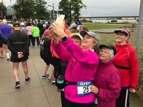 Leslie Campbell of Surrey takes a group photo before Sunday's Forever Young 8K, held at the Richmond Olympic Oval. One hundred and sixty-five runners and walkers, ranging in age from 55 to 99, took part in the fifth annual event.
