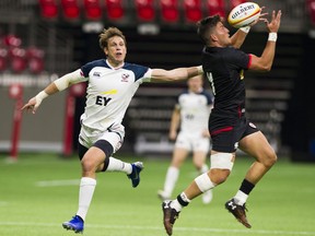 Canada’s DTH van der Merwe (right) gathers in the ball against USA defender Blaine Scully during the teams’ pre-World Cup match at B.C. Place Stadium earlier this month.