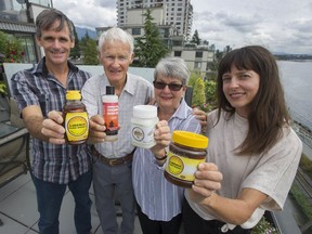 Kent Bubbs Jr., (left to right) Kent Bubbs Sr., Gerry Bubbs and Landis Wyatt hold examples of products made from honey which they help produce in Liberia through their humanitarian organization Universal Outreach Foundation. Photo: Jason Payne/Postmedia