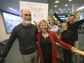 Vancouver cyclist Deirdre Arscott and her husband Bob Lepage are greeted by friends Barb Lepsoe, Susan Barr and Eric Fergusson (in the background) after the couple landed at Vancouver International Airport on Saturday. Arscott was coming from France, where she completed the quadrennial 1,200 km Paris-Brest-Paris cycling event for the ninth time, setting a record for all female finishers.