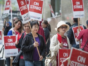 Striking hospitality workers picket the Hyatt Regency hotel in downtown Vancouver on Saturday. Approximately 400 members of Unite Here Local 40 are on strike at the hotel.
