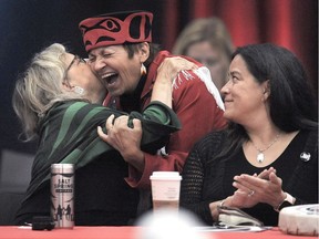 Green party Leader Elizabeth May, left, hugs Joan Phillip, NDP Candidate for Central Okanagan-Similkameen-Nicola, as Independent candidate for Vancouver-Granville Jody Wilson Raybould looks on at the B.C. Assembly of First Nations 16th Annual General Meeting at the Musqueam Recreation Centre in Vancouver on Sept. 19.