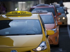 Taxis await customers in downtown Vancouver.