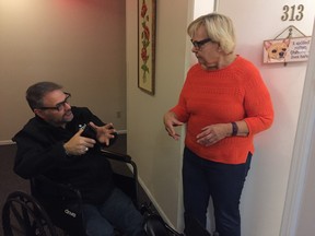 Pitt Meadows-Maple Ridge Liberal incumbent Dan Ruimy  speaks to constituent Sylvia Dorey Sunday. He is  campaigning in a wheelchair after breaking his foot this summer. Photo by Lori Culbert