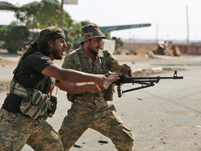 Turkish-backed Syrian fighters take part in a battle in Syria's northeastern town of Ras al-Ain in the Hasakeh province along the Turkish border.