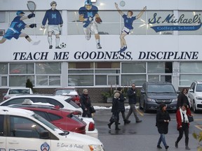 Parents, police and security could be seen guarding the back student's entrance doors at the rear of St. Michael's College on Bathurst St.