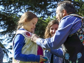 Perry Bellegarde, national chief of the Assembly of First Nations, presents Swedish climate activist Greta Thunberg with a native vest in Montreal last month. Bellegarde likens UNDRIP as an opportunity to say yes or no.