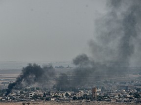 Smoke rises from the Syrian town of Ras al-Ain, in a picture taken from the Turkish side of the border in Ceylanpinar on October 11, 2019.