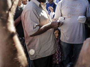 A day after a fatal fire killed at least two and clashes between asylum seekers and police took place, asylum seekers pack their belongings and board buses at the Moira camp that will take them to the Mytilene port where they will be ferried to Athens, on September 30, 2019 in Mytilene, Greece. Authorities planned to move 200+ asylum seekers from the camp on Lesvos Island in Greece.