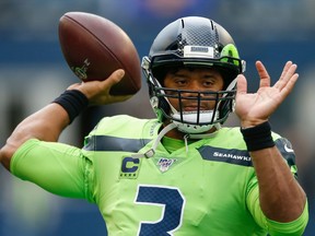 Quarterback Russell Wilson warms up prior to the game against the Los Angeles Rams at CenturyLink Field on October 3.