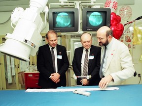 From 1990, B.C. Health Minister John Jansen and Fraser-Burrard Hospital Society chair Michael Milaney look at Royal Columbian Hospital’s cardiac catheterization lab with Dr. Mark Henderson just before it opens to the public.