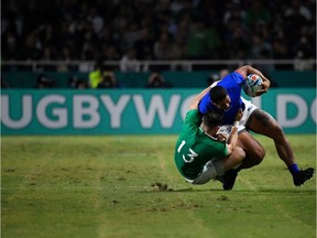 TOPSHOT - Ireland's centre Robbie Henshaw (L) tackles Samoa's wing Ed Fidow during the Japan 2019 Rugby World Cup Pool A match between Ireland and Samoa at the Fukuoka Hakatanomori Stadium in Fukuoka on October 12, 2019. (Photo by CHRISTOPHE SIMON / AFP)