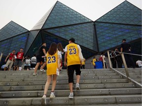 Fans wearing LeBron James shirts arrive to watch the NBA pre-season game between the L.A. Lakers and Brooklyn Nets in Shenzhen last weekend.
