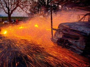 Fire and embers blow around a burnt utility truck during the Kincade fire in Healdsburg, Calif., Oct. 27, 2019. (JOSH EDELSON/AFP via Getty Images)