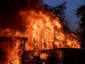 A home is engulfed in flames as the Kincade fire continues in Healdsburg, California on October 27, 2019.