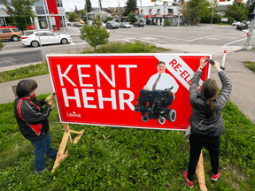 Volunteers put up a campaign sign for Calgary Centre Liberal candidate Kent Hehr. Hehr is one of the three federal Liberal incumbents in Alberta.