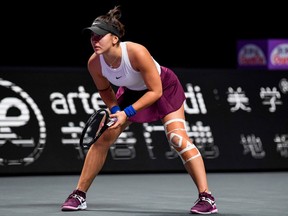 Bianca Andreescu of Canada is seen with a bandaged in her knee during her women's singles match against Karolina Pliskova of Czech Republic during their women's singles match at the WTA Finals tennis tournament in Shenzhen on October 30, 2019. - ndreescu withdraw from the match because of the injury.
