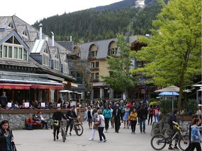 In this file photo, people walk down a street in the village of Whistler, BC.