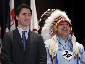 Prime Minister Justin Trudeau stands with Assembly of First Nations National Chief Perry Bellegarde during the Assembly of First Nations Special Chiefs Assembly in Gatineau, Canada, December 8, 2015.