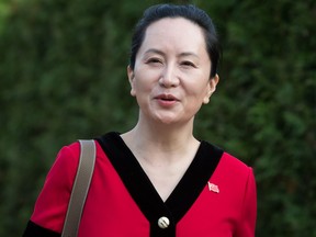 Huawei chief financial officer Meng Wanzhou, who is out on bail and remains under partial house arrest after she was detained last year at the behest of American authorities, wears a Chinese flag pin on her dress as she leaves her home to attend a court hearing in Vancouver, on Tuesday October 1, 2019.