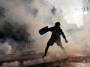 An anti-government protester throws an object during a demonstration on China's National Day, in Wong Tai Sin, Hong Kong, China October 1, 2019.