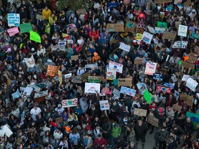Thousands of people gather outside Vancouver City Hall before marching downtown during a climate strike in Vancouver on Friday, Sept. 27,