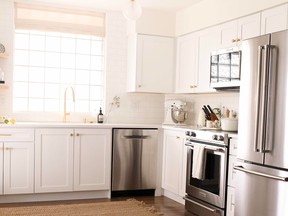 Open shelving, subtle lighting and high window treatments, creates a light and airy kitchen in this downtown Vancouver condo.