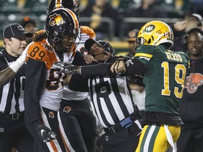 A ref tries to break up a skirmish between B.C. Lions' Duron Carter (89) and Edmonton Eskimos' Tyquwan Glass (19) during second half CFL action in Edmonton on Saturday, Oct. 12, 2019.