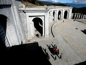 Relatives of late Spanish dictator Francisco Franco carry his coffin after the exhumation at The Valle de los Caidos (The Valley of the Fallen) in San Lorenzo de El Escorial, Spain, October 24, 2019.