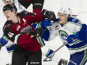Vancouver Giants defenceman Bowen Byram battles with Swift Current's Carter Chorney at the Langley Events Centre on Saturday, Oct. 19, 2019.