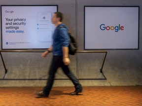A pedestrian walks past Google privacy and security settings signage displayed at the Capitol South Metro subway station in Washington, D.C., U.S., on Tuesday, Oct. 22, 2019.