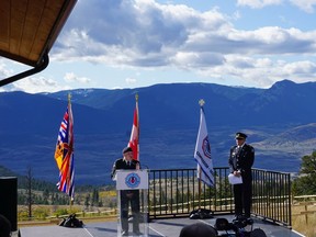 Allan De Genova, the president of Honour House Society, addressing the crowd of more than 300 on Saturday in Thompson River Valley, with B.C. Ambulance Services paramedic Bob Parkinson to the right.