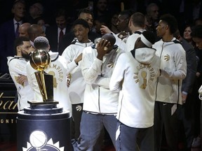 Raptors players take part in the ring ceremony and banner-raising prior their season opener at Scotiabank Arena on Monday night. (Jack Boland/Toronto Sun)