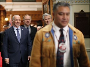 Regional Chief Terry Teegee leaves the legislative assembly joined by Premier John Horgan, B.C. Green Party leader Andrew Weaver and B.C. Liberal leader Andrew Wilkinson following an announcement about Indigenous human rights being recognized in B.C. with new legislation during a press conference at the provincial Legislature in Victoria, Thursday, Oct. 24, 2019.