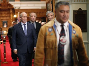 Regional Chief Terry Teegee leaves the legislative assembly joined by Premier John Horgan, B.C. Green Party leader Andrew Weaver and B.C. Liberal leader Andrew Wilkinson following an announcement about Indigenous human rights being recognized in B.C. with new legislation during a press conference at the provincial Legislature in Victoria, Thursday, Oct. 24, 2019.
