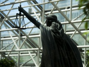 Vancouver, BC: April 05, 2016 --   Scales of Justice statue at BC Supreme Court in Vancouver, BC Thursday, May 5, 2016.