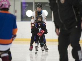 Four-year-old Beatrice Quan receives some help skating at Killarney ice rink in Vancouver on Oct. 5 as part of the Come Try Hockey girls' program.