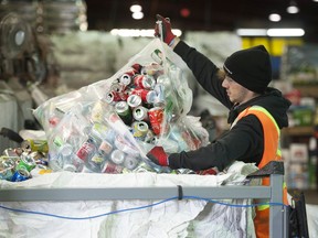 Sorter Hugo Berger sifts through cans and bottles at Regional Recycling Vancouver on Glen Drive in Vancouver.