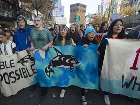 People march in downtown Vancouver, Friday, October 25, 2019 to protest the state of the global environment and listen to speakers, including Swedish climate activist Greta Thunberg.