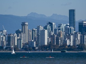 Kayakers takes to the waters of Burrard Inlet on a clear and sunny fall day in Vancouver, BC.